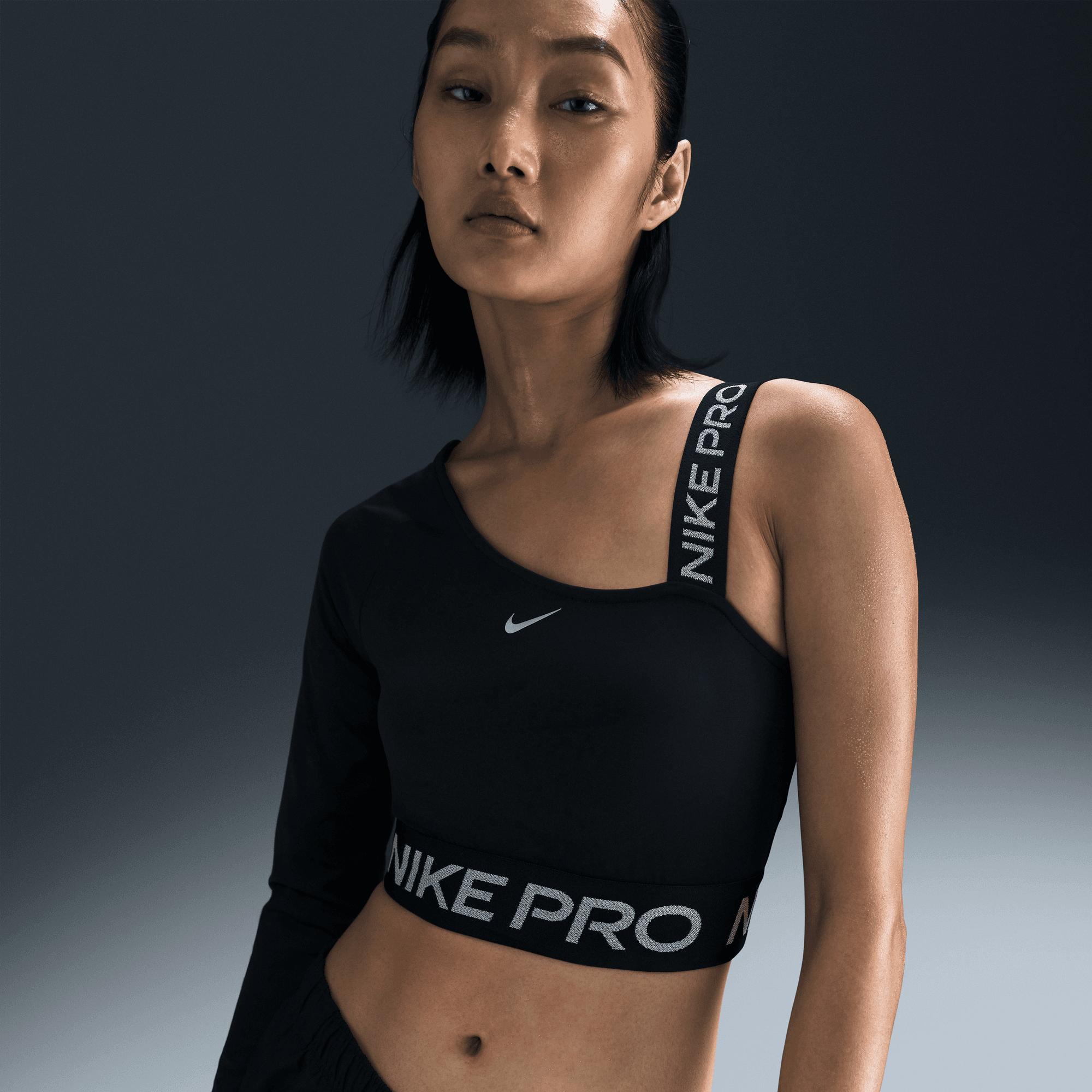 NIKE PRO SHINE WOMEN'S DRI-FIT ASYMMETRICAL CROPPED TOP